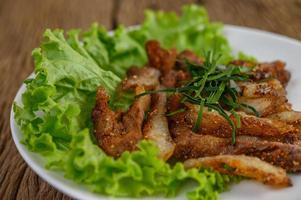 Grilled pork neck on a wooden table photo