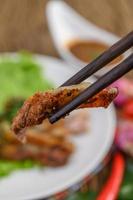 Grilled pork neck on a wooden table photo