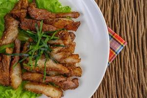 Grilled pork neck on a wooden table photo