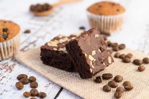 Chocolate brownies on a sackcloth with coffee beans photo