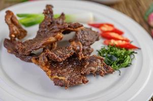 Beef fried Thai food with spring onion, lime, chili and salad photo
