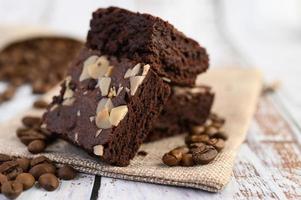 Chocolate brownies on a sackcloth with coffee beans photo