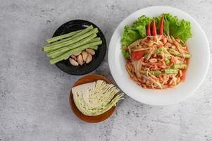 Thai papaya salad with beans, collards and garlic photo