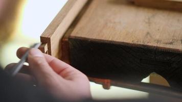 Joiner Carves a Dovetail Joint With a Wood Chisel video