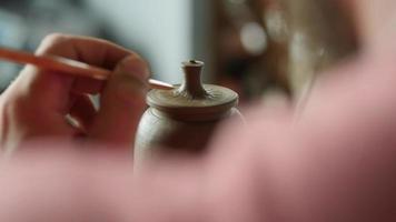 Potter Decorates The Lid of A Clay Teapot video