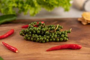 Fresh pepper seeds and chili on a wooden table photo