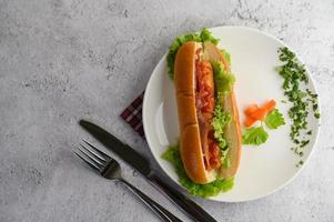 Hotdog placed on a white dish beautifully photo