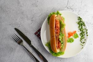 Hotdog placed on a white dish beautifully photo