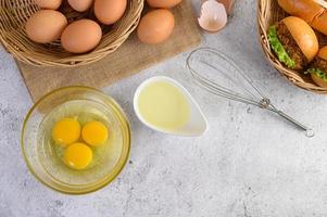 Fresh brown eggs and bakery products on a neutral background