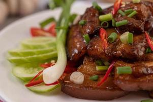 Sweet pork with chopped scallions, chili, lime, cucumber, tomato and garlic photo