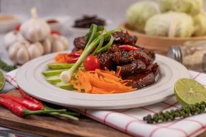 Sweet pork with chopped scallions, chili, lime, cucumber, tomato and garlic photo