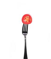 Red hot chili pepper on fork isolated on white photo