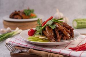 Sweet fried chicken feet with coriander, chili, cucumber and tomato photo