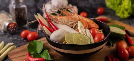 Tom Yum Kung soup with tomato, chili, lemongrass, garlic, lemon, and kaffir photo