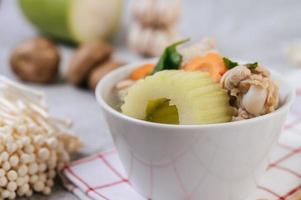 Chicken soup with corn, shiitake mushroom, enoki mushroom and carrot photo