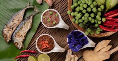 Shrimp paste and mackerel, fried on banana leaves with chili, tomato and garlic photo