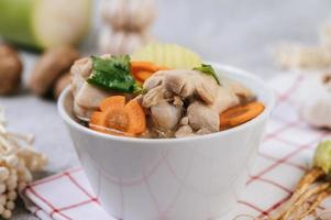 Chicken soup with corn, shiitake mushroom, enoki mushroom and carrot photo
