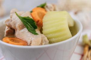 Chicken soup with corn, shiitake mushroom, enoki mushroom and carrot photo