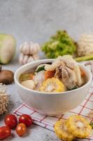 Chicken soup with corn, shiitake mushroom, enoki mushroom and carrot photo