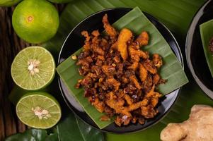 Crispy pork chili paste on banana leaves with side dishes photo
