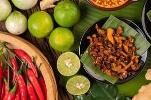 Crispy pork chili paste on banana leaves with side dishes photo
