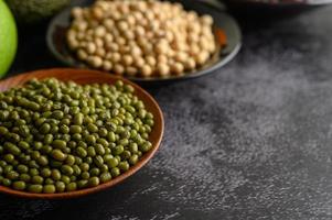 Mung beans, red bean and soybeans on a black cement floor background