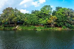 Houses on the Chanthaburi River with cloudy blue sky photo