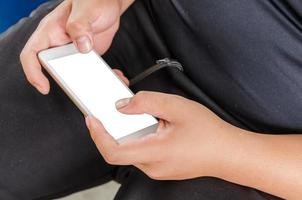 Person typing on mockup smartphone photo