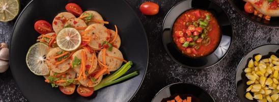 Vietnamese pork sausage salad with chilli, lemon, garlic and tomato photo