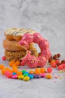 Assorted stack of donuts on neutral background