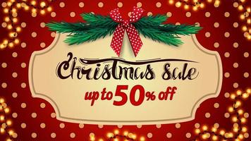 Christmas sale, up to 50 off, red discount banner with polka dot texture on background, vintage frame, christmas tree branches and red bow vector