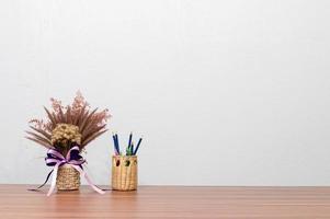 Pens and flowers on a desk photo