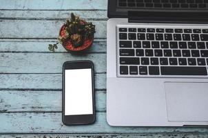 Laptop and smartphone on a table photo