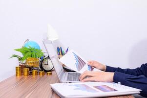 Person holding a paper with line graphs photo