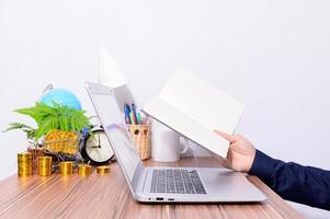 Professional holding a book at a desk photo