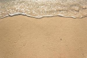 Ocean waves on sandy beach photo