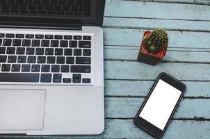 Laptop and smartphone on table photo