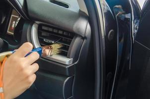 Brushing car air vents clean photo