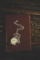 Close up of a vintage pocket watch on old books photo
