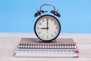 Alarm clock on notebooks photo