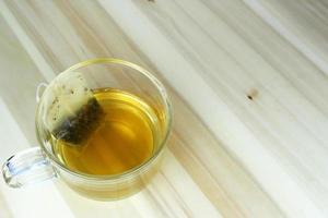 Cup of tea on wooden table photo