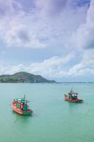 Small fishing boats moored in the sea photo