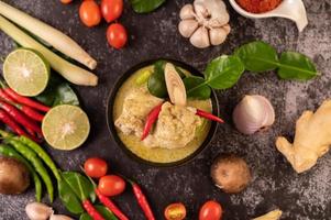 Green curry dish with chicken, chili and basil and tomato and lime photo