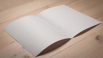 White blank folded paper on wooden table photo