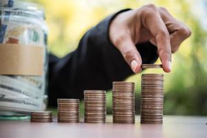 Money in a glass jar in nature, investment concept photo