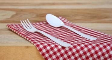 Fork and spoon on red cloth photo