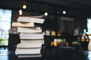 A stack of books on a table in a cafe photo