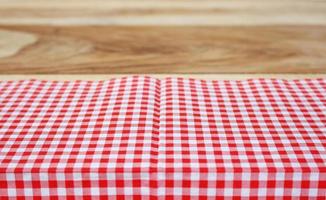 Red cloth on wooden table photo