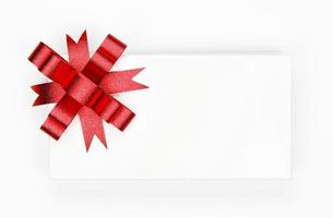 Red bow on a white package photo