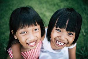 Two little girls having fun playing in the park photo